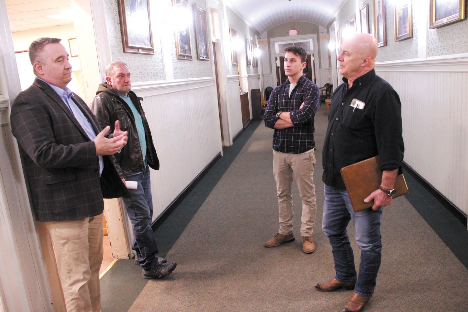 ON THE WAY OUT: Ward 3 Councilman Timothy Howe stopped to chat with members of the Warwick Landlords Association after last Wednesday’s council meeting following first passage of an ordinance regulating short-term rentals. He is talking with Sean Hennessey, who owns an Airbnb in Conimicut, and William Gagnier and his son Van who operate an Airbnb in Pawtuxet. (Warwick Beacon photo)